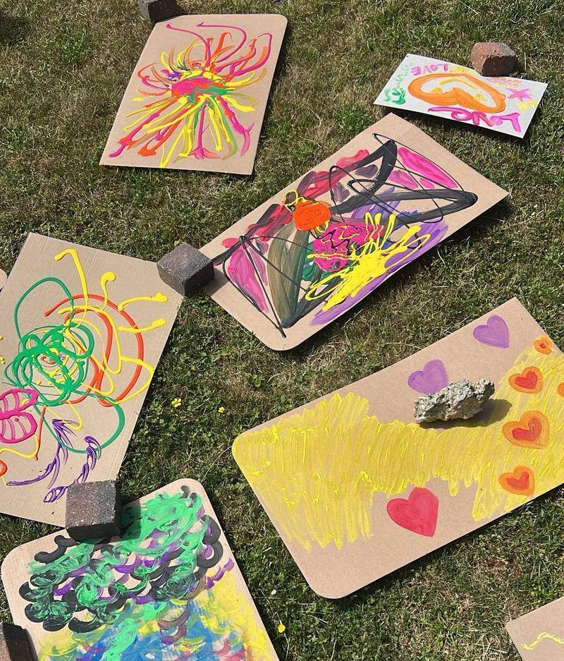 Colourful paintings drying on the grass