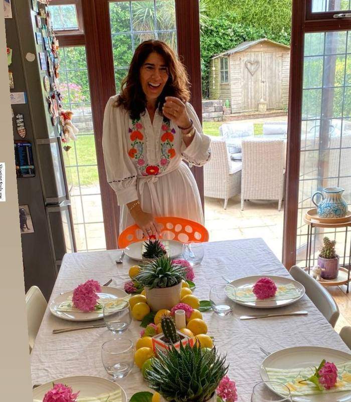 Marina laughing as she sets the table before a workshop